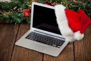 Laptop with santa hat on a plank